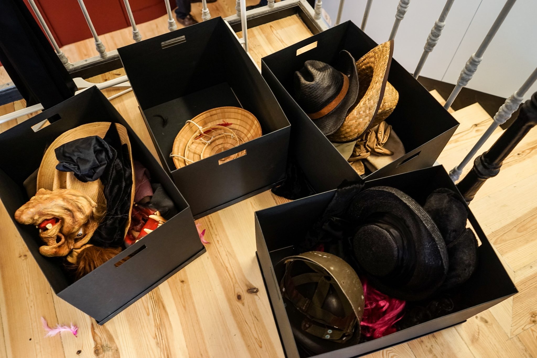 Caixas pretas com adereços, incluindo chapéus e máscaras