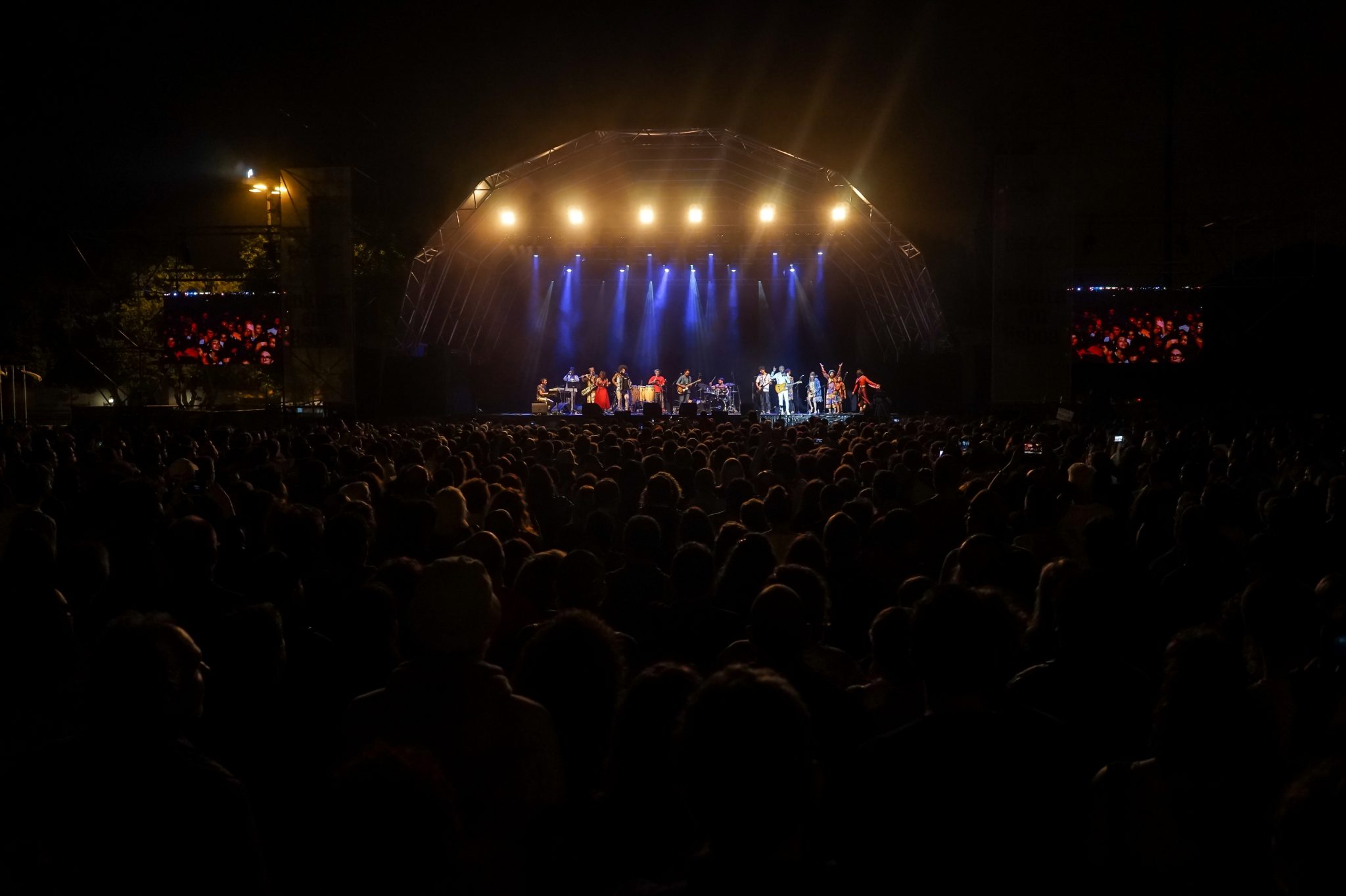 Vista geral do público que assistiu ao concerto Refavela 40, com o palco ao fundo repleto de músicos
